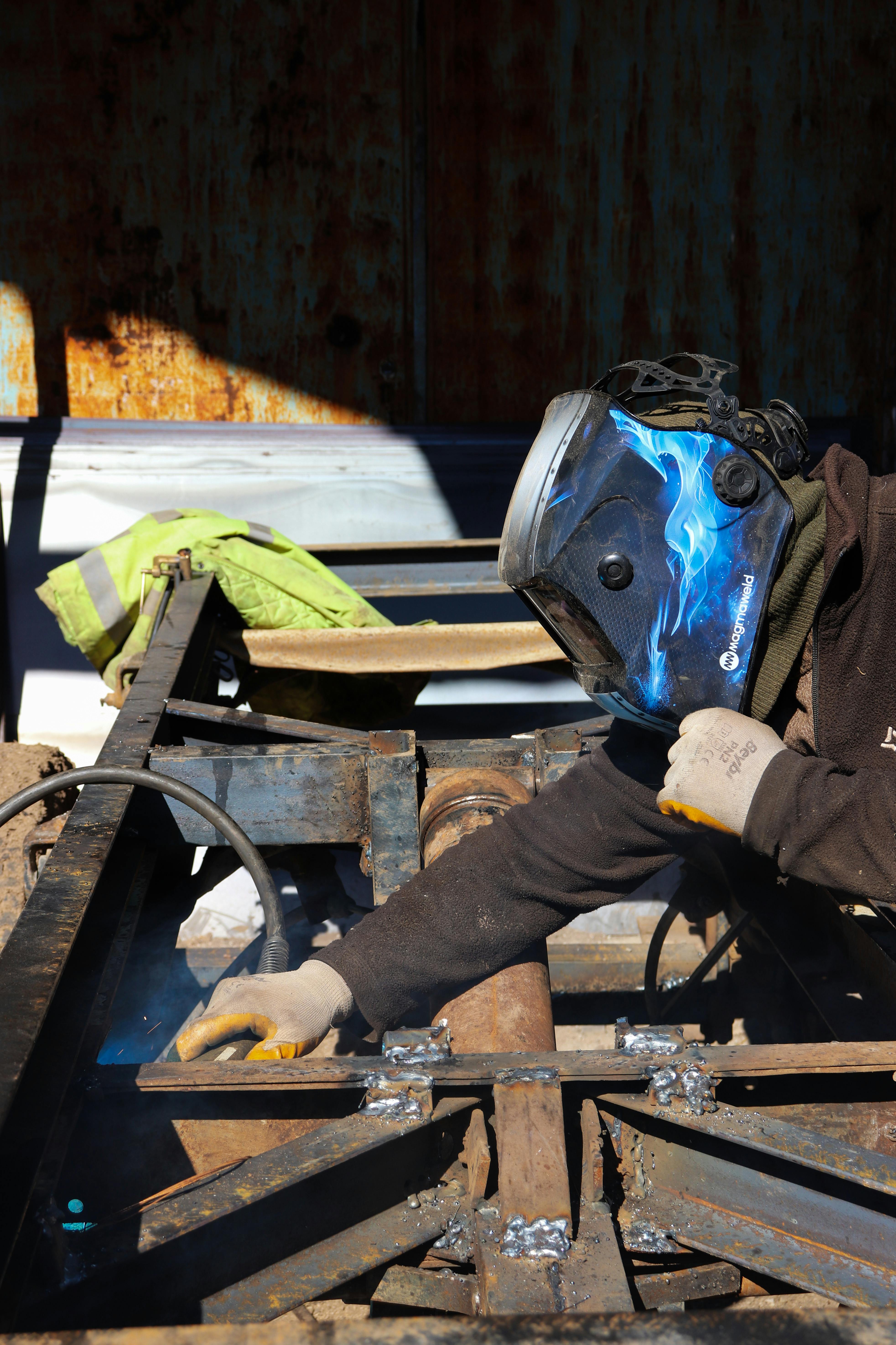 Welder working on structural steel beam