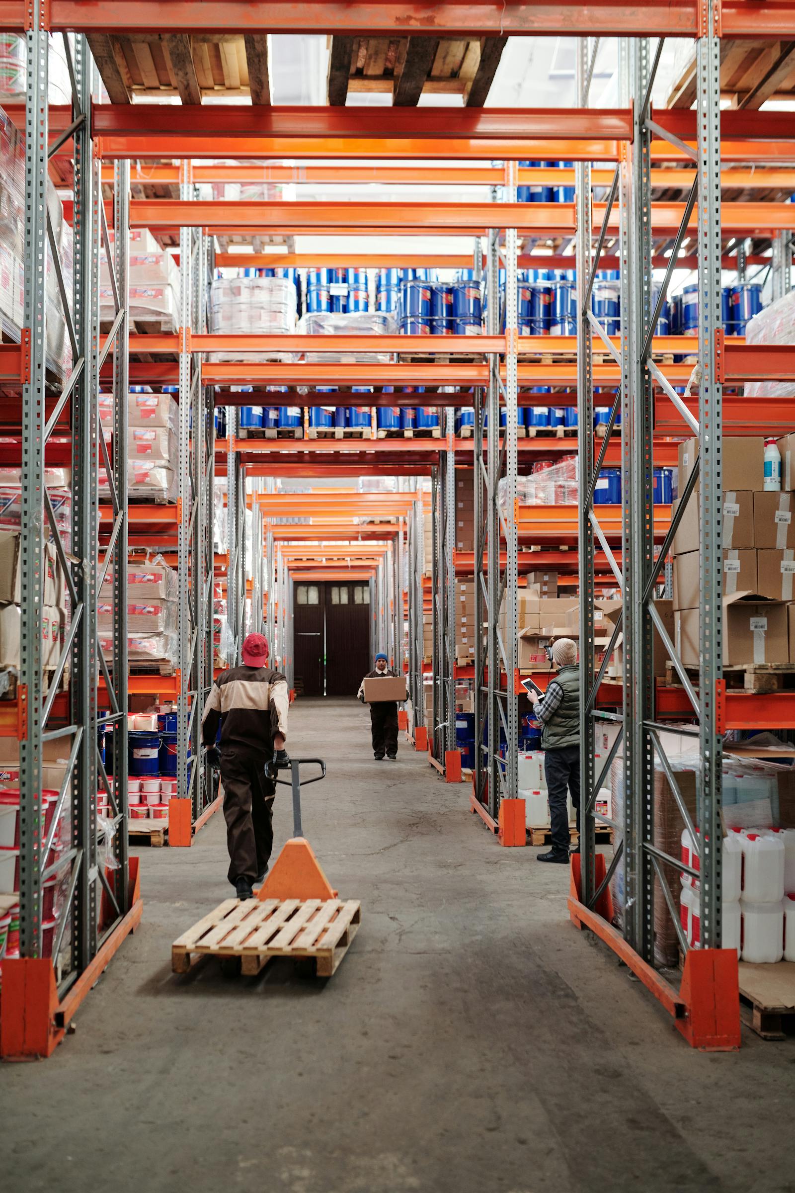 Daxonet supply-chain engineer with Malaysian warehouse manager reviewing AI-Powered WMS dashboard